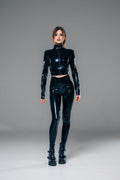 Black latex crotchless leggings with a zip crop top, full length view