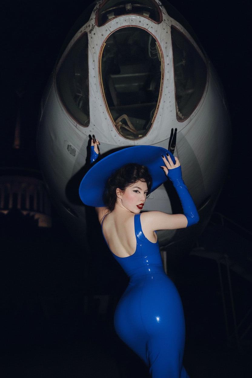 Royal blue latex dress and gloves seen from the back