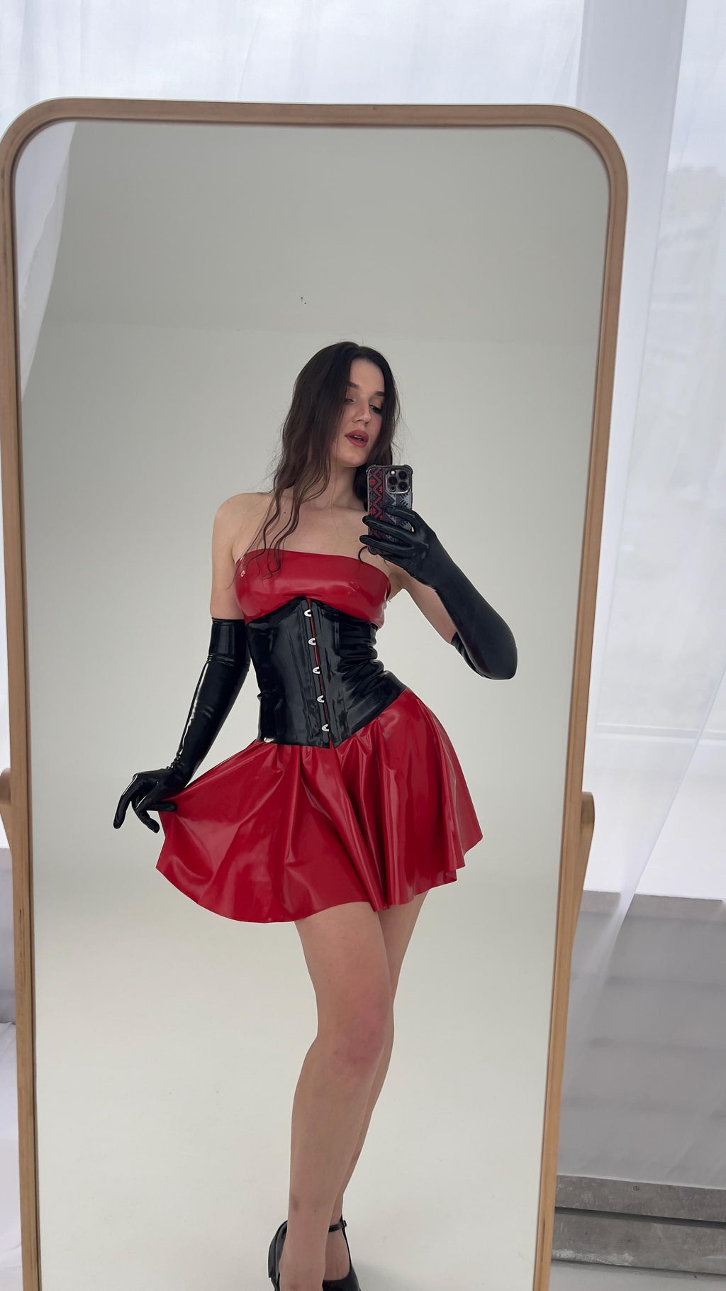 Red latex off shoulder dress with black corset and long gloves, full length