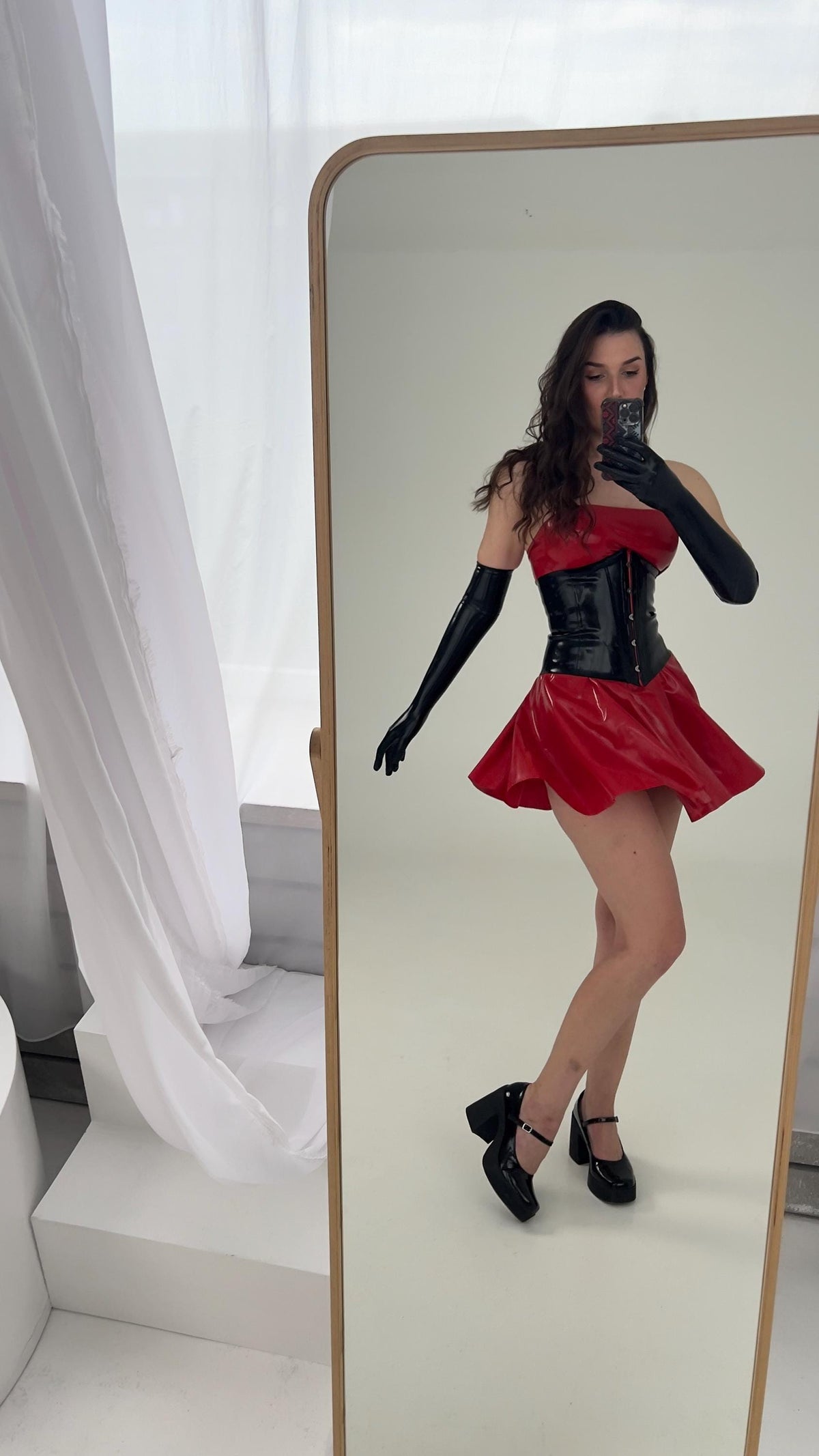 Red latex dress with black latex corset, front view